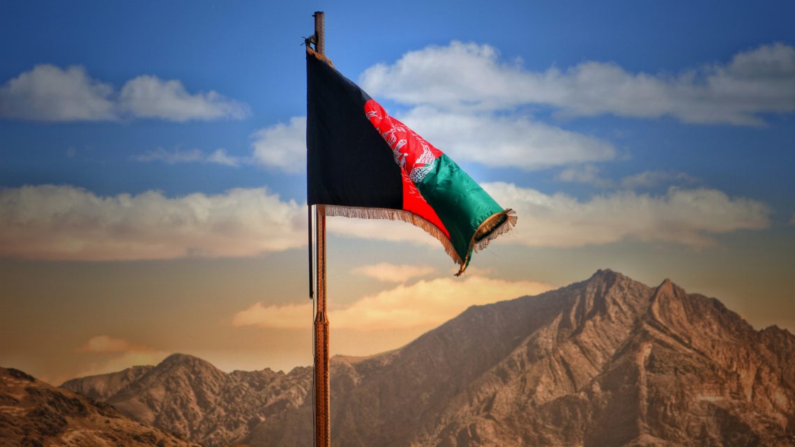 https://unsplash.com/photos/a-flag-on-a-pole-with-mountains-in-the-background-kNDirqnZn8M